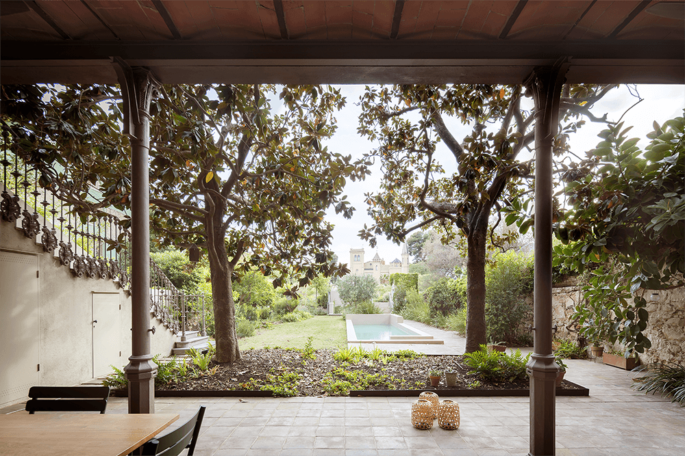 Patio with a lush garden and pool view